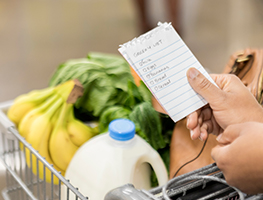 Woman holding a shopping list while grocery shopping