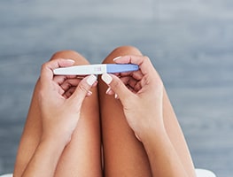 Woman holding a home pregnancy test
