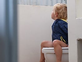 Toddler sitting on a toilet