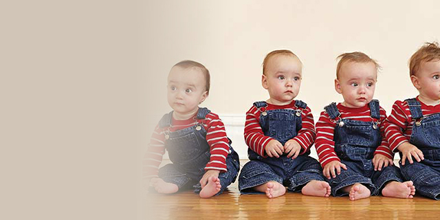 Quadruplets dressed in denim and red shirts